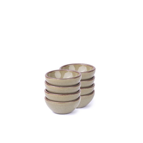 A stack of 8 tiny rounded ceramic bowls in a reflective dappled grey-green color featuring an unglazed rim