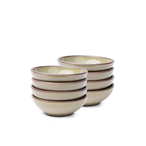 A stack of 8 small shallow ceramic bowls in a reflective dappled grey-green color featuring an unglazed rim