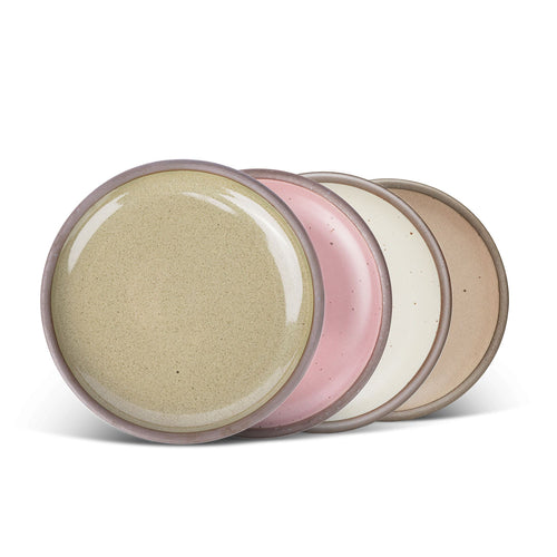 4 medium sized ceramic plates in a dusty mauve pink, reflective dappled grey-green, warm off-white, and warm pale brown colors featuring iron speckles and an unglazed rim.