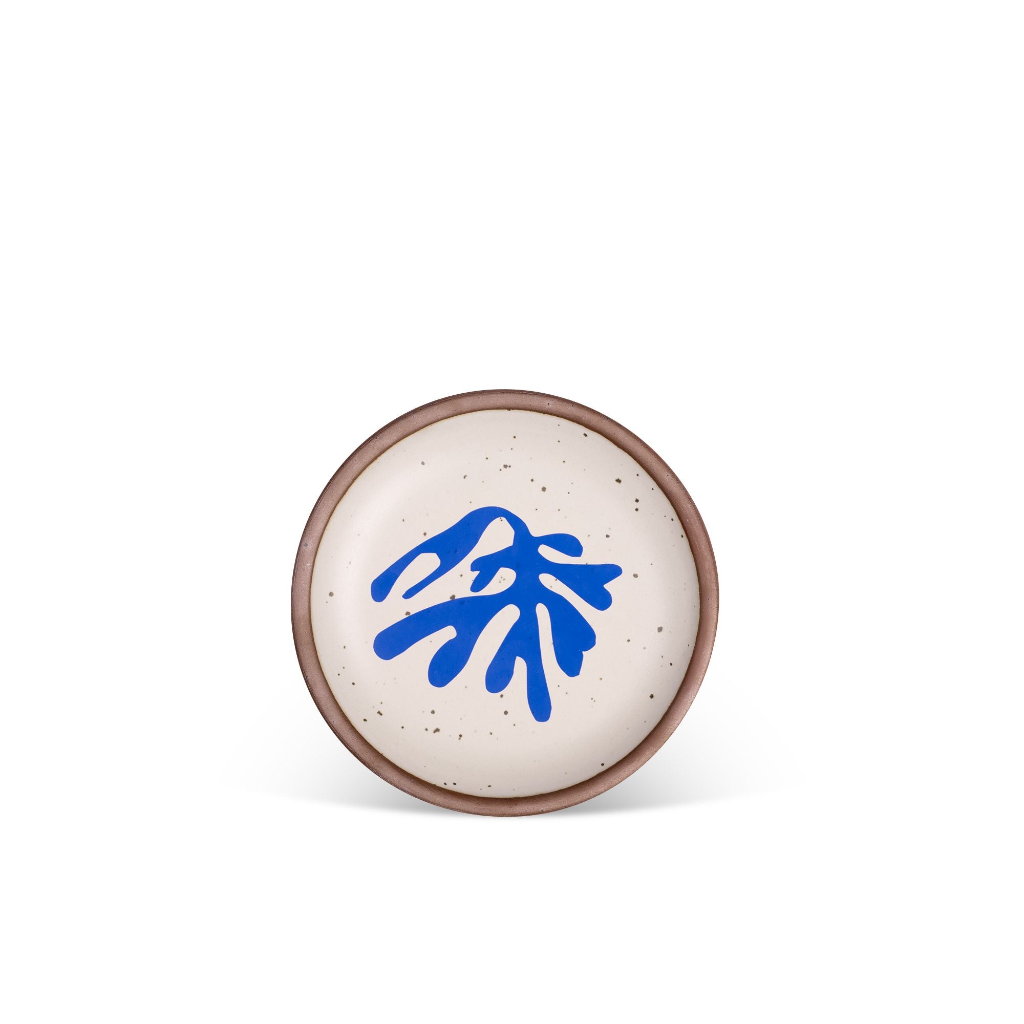 A ceramic dessert sized plates in a warm off-white color with unglazed rim, a frond-like cut-outs from Henri Matisse’s La Perruche et la sirène.