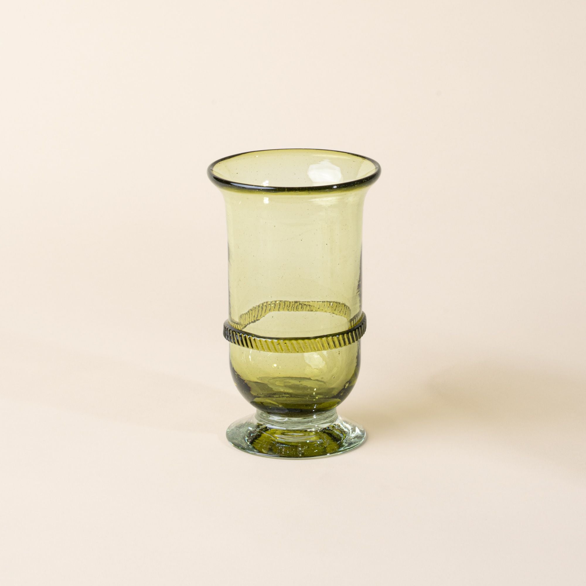 Light green glass vase with a flared rim, pedestal base, and decorative band detail at the center, set against a neutral background.