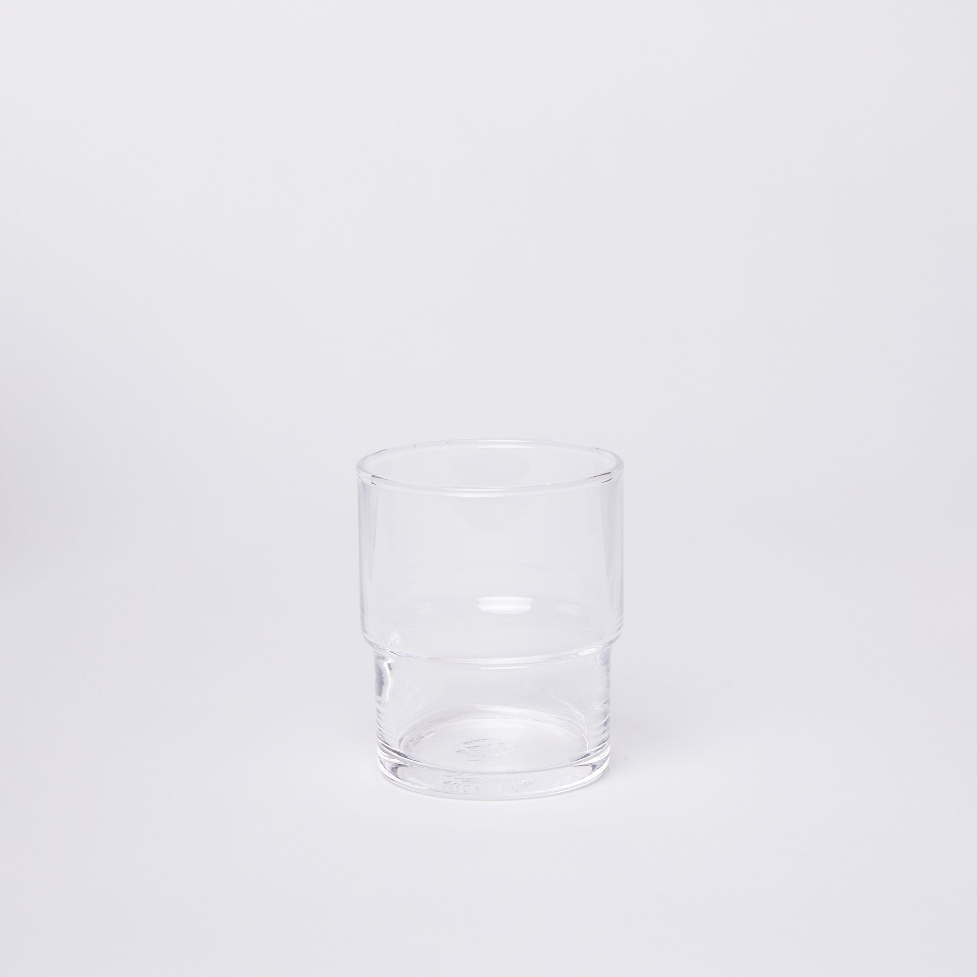 Clear cylindrical glass with a wider top half with a narrower bottom half