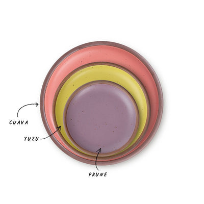 A stack of 3 plates in Dinner, Side, and Cake sizes in a watermelon pink, zesty yellow, and soft mauve purple colors.