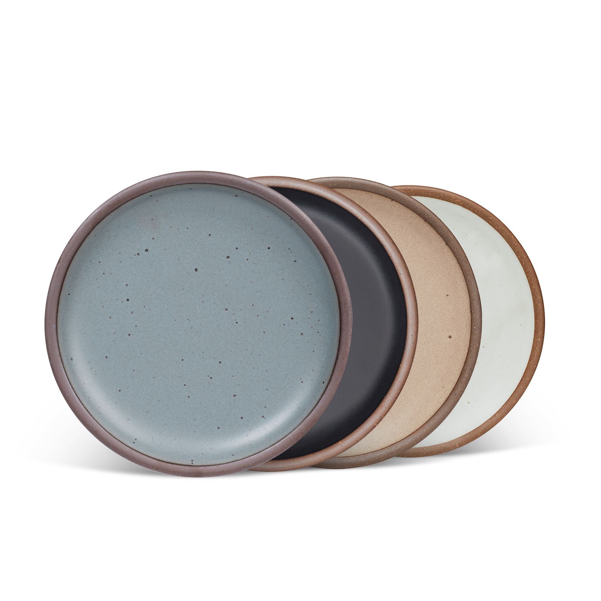 4 medium sized ceramic plates in a blue-grey, graphite black, warm pale brown, and cool white colors featuring iron speckles and an unglazed rim.