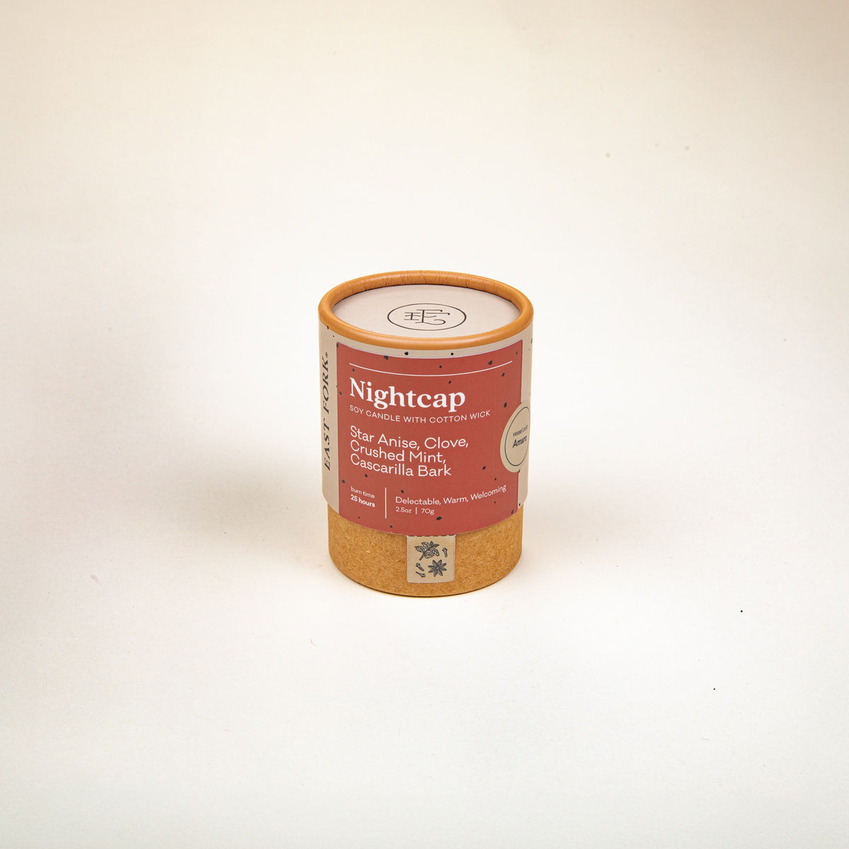 Small cardboard packaging tube with a candle inside with branding on it that says 'Nightcap'