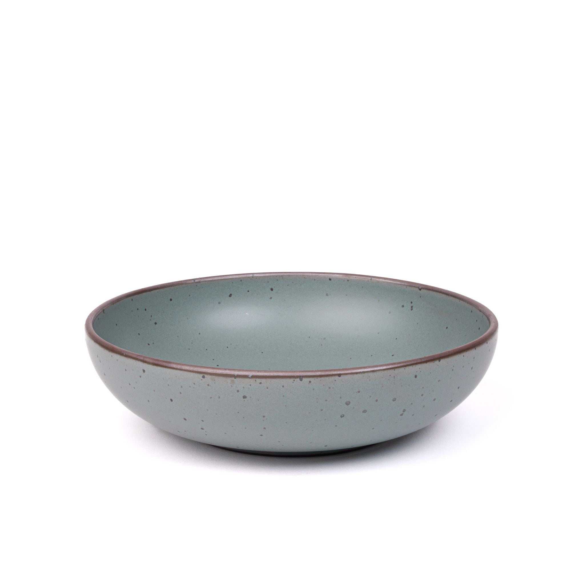 A large shallow serving ceramic bowl in a blue-grey color featuring iron speckles and an unglazed rim.