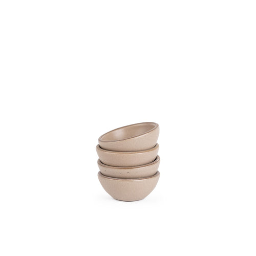 A stack of 4 tiny rounded ceramic bowls in a warm pale brown color featuring iron speckles and an unglazed rim
