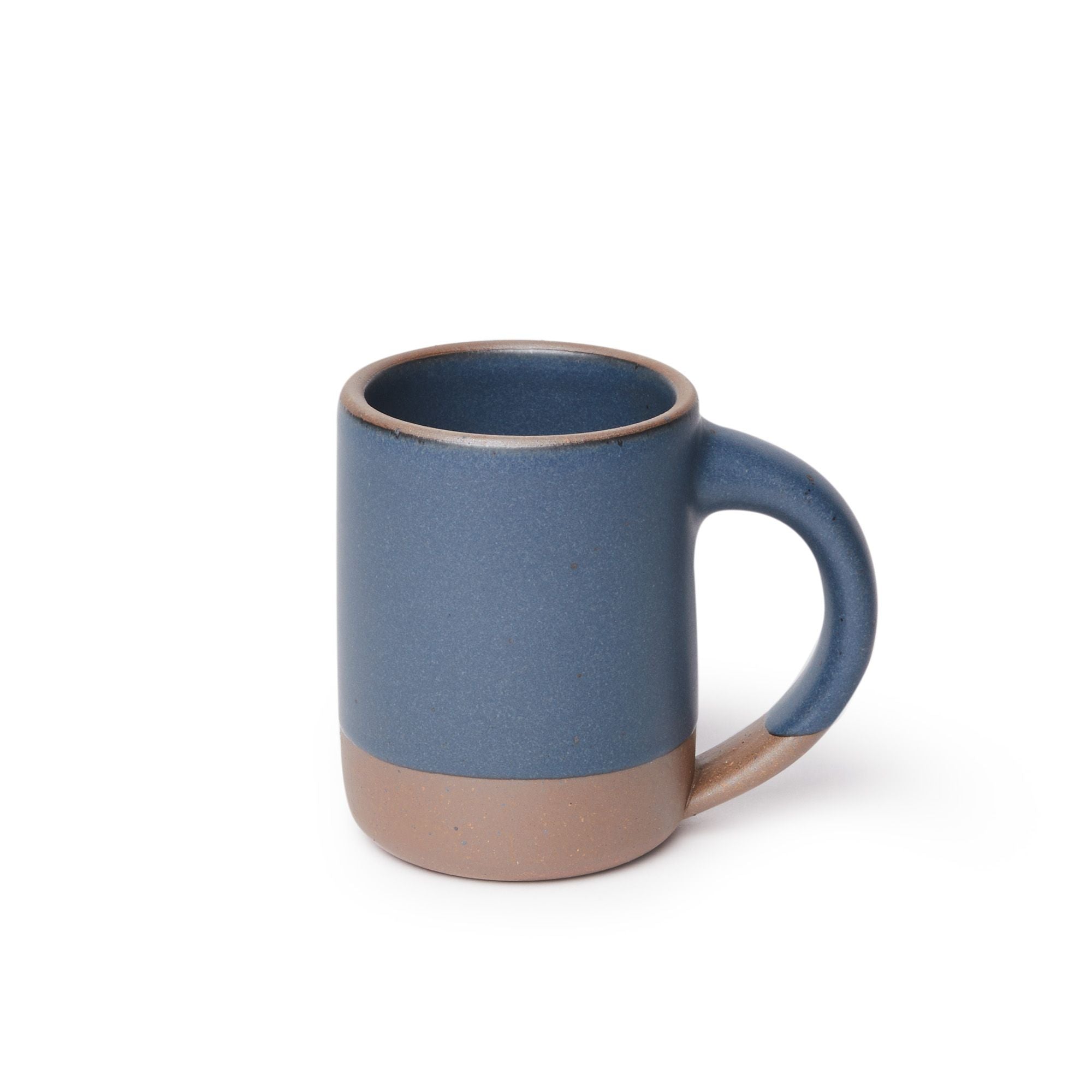 A medium sized ceramic mug with handle in a cool medium blue color featuring iron speckles and unglazed rim and bottom base.