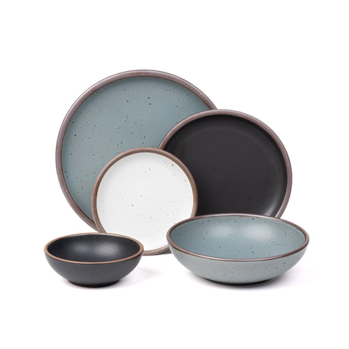 A breakfast bowl and side plate in graphite black, an everyday bowl and dinner plate in blue-grey, and a cake plate in a cool white color.