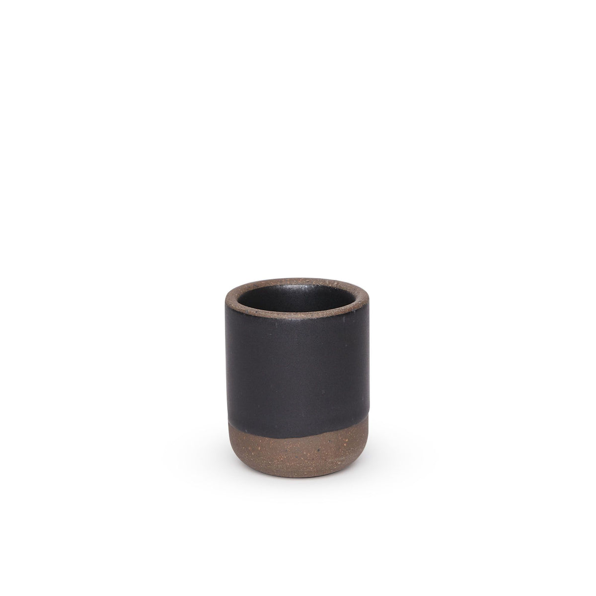 A small, short ceramic mug cup in a graphite black color featuring iron speckles and unglazed rim and bottom base.