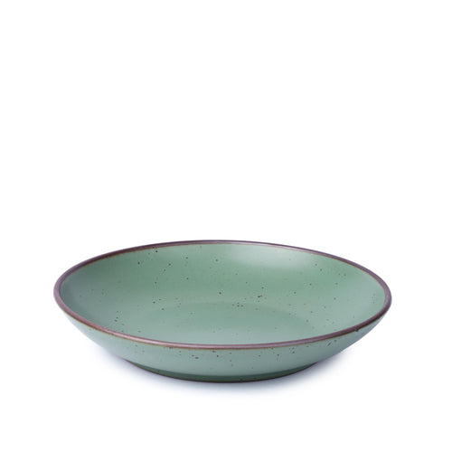 A shallow ceramic bowl-plate with a wide rim for composed dishes in a viridian green glaze with a matte finish.