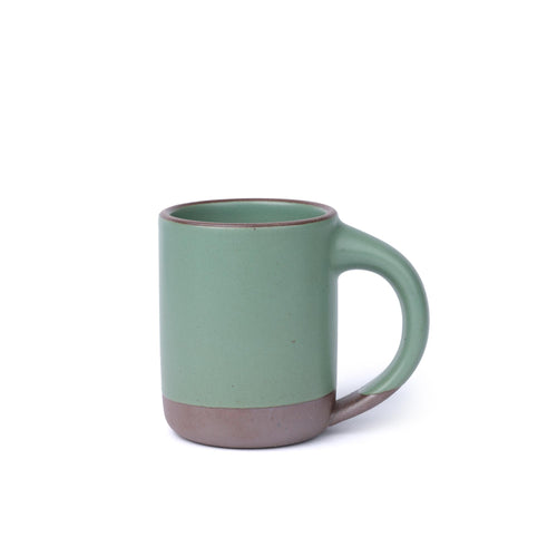 Ceramic mug with straight sides and handle, made from iron-rich speckled stoneware with a raw rim in a viridian green glaze with a matte finish.