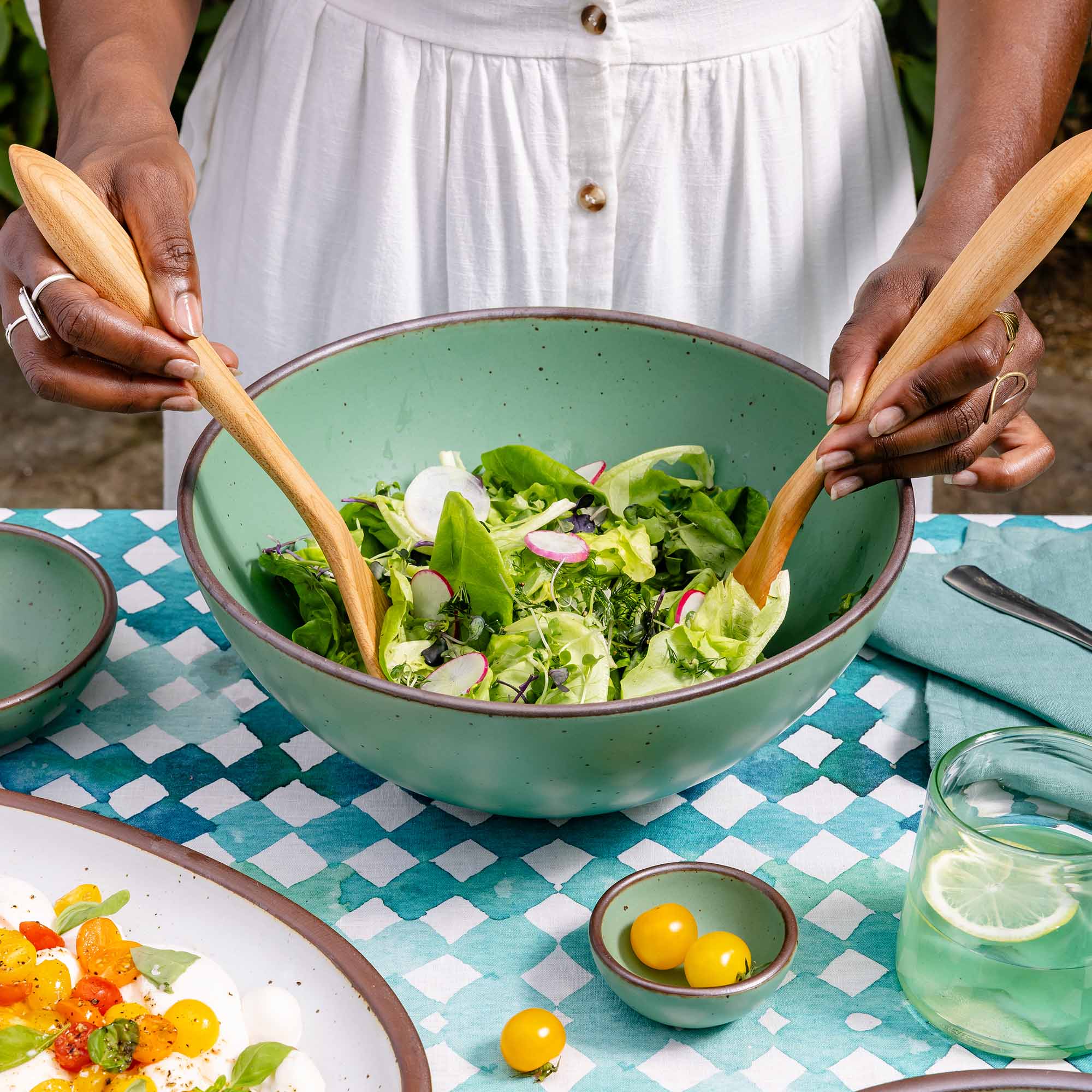 A deep ceramic bowl with a wide rim for mixing or serving in a viridian green glaze with a matte finish.