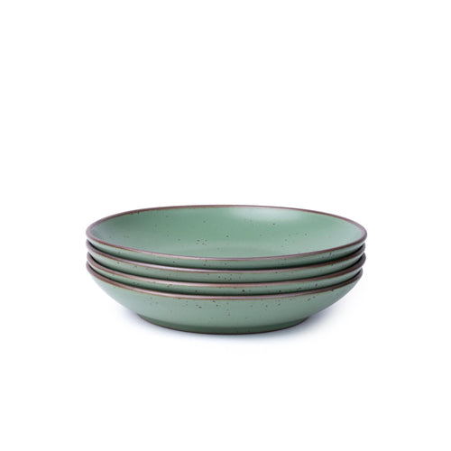 Four shallow ceramic bowl-plates with a wide rim for composed dishes in a viridian green glaze with a matte finish.