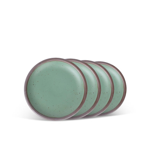Four ceramic plates with flat surfaces and raised edges in a viridian green glaze with a matte finish.