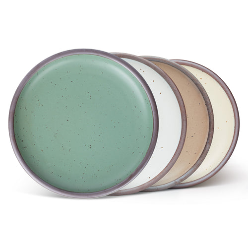 Four ceramic plates with a wide surface and low rims in a viridian green, warm brown, warm white and cool white glazes.