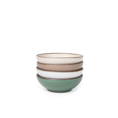 Four shallow ceramic bowls for cereal or yogurt in a viridian green, warm brown, warm white and cool white glazes.