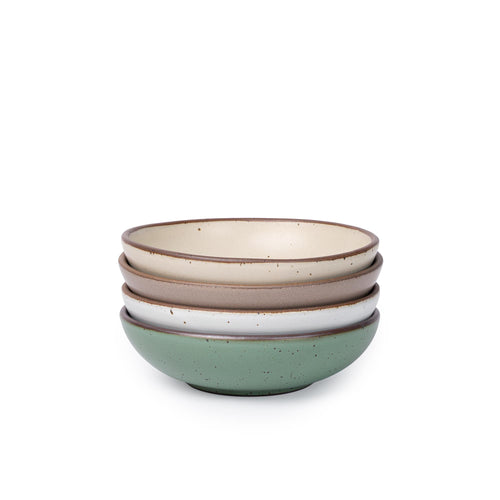 Four shallow ceramic bowls for daily meals in a viridian green, warm brown, warm white and cool white glazes.