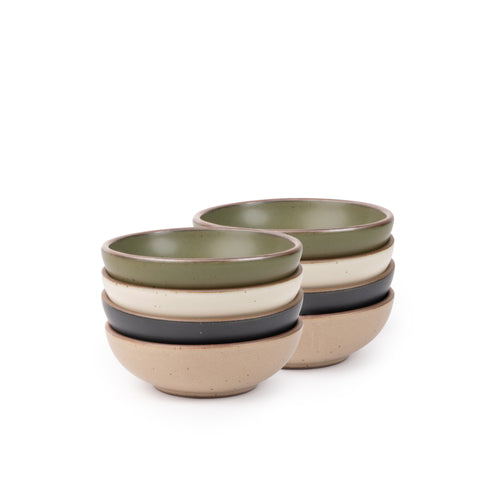 8 small shallow ceramic bowls in an olive green, graphite black, off-white, and warm pale brown colors featuring iron speckles and an unglazed rim