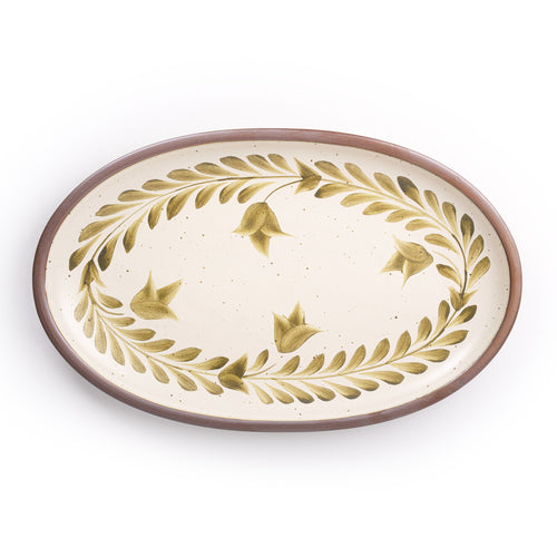 Oval ceramic platter with a hand-painted olive green leaf and flower border on a cream background with an exposed clay rim.