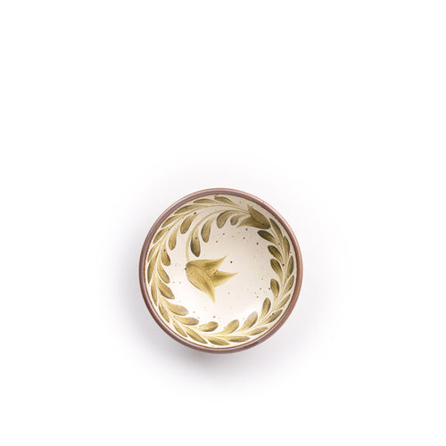 Overhead view of a Small ceramic shallow bowl with a hand-painted olive green leaf border on a cream interior and speckled cream exterior with an exposed clay rim.