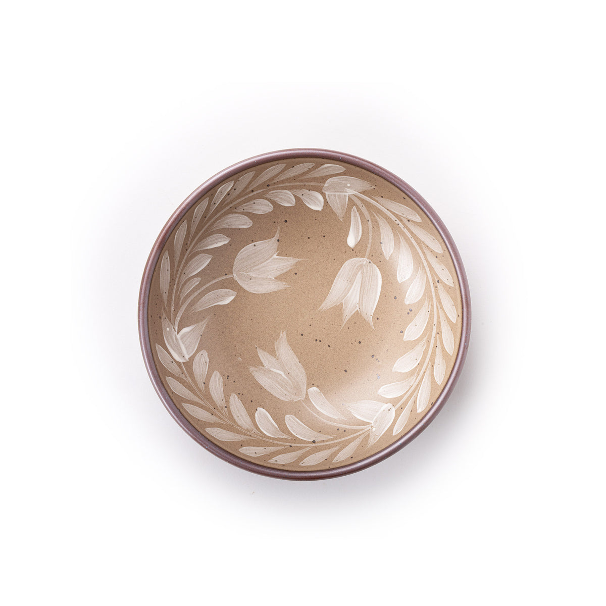 Overhead of a Medium ceramic shallow bowl with a hand-painted white leaf border on a pale warm brown interior and exterior with an exposed clay rim.