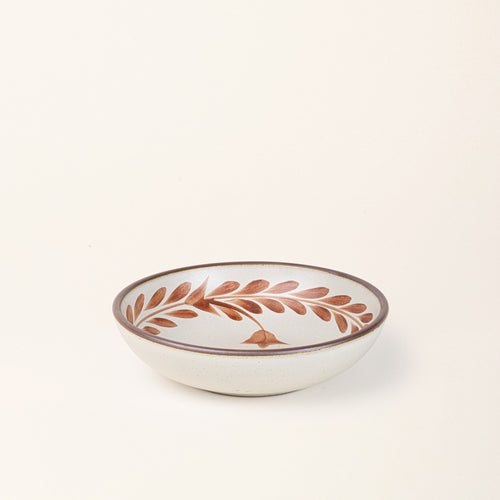 Medium ceramic shallow bowl with a hand-painted terracotta leaf border on a cream interior and exterior with an exposed clay rim.