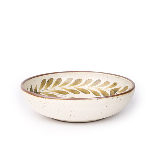 Large ceramic shallow bowl with a hand-painted olive green leaf border on a cream interior and exterior with an exposed clay rim.