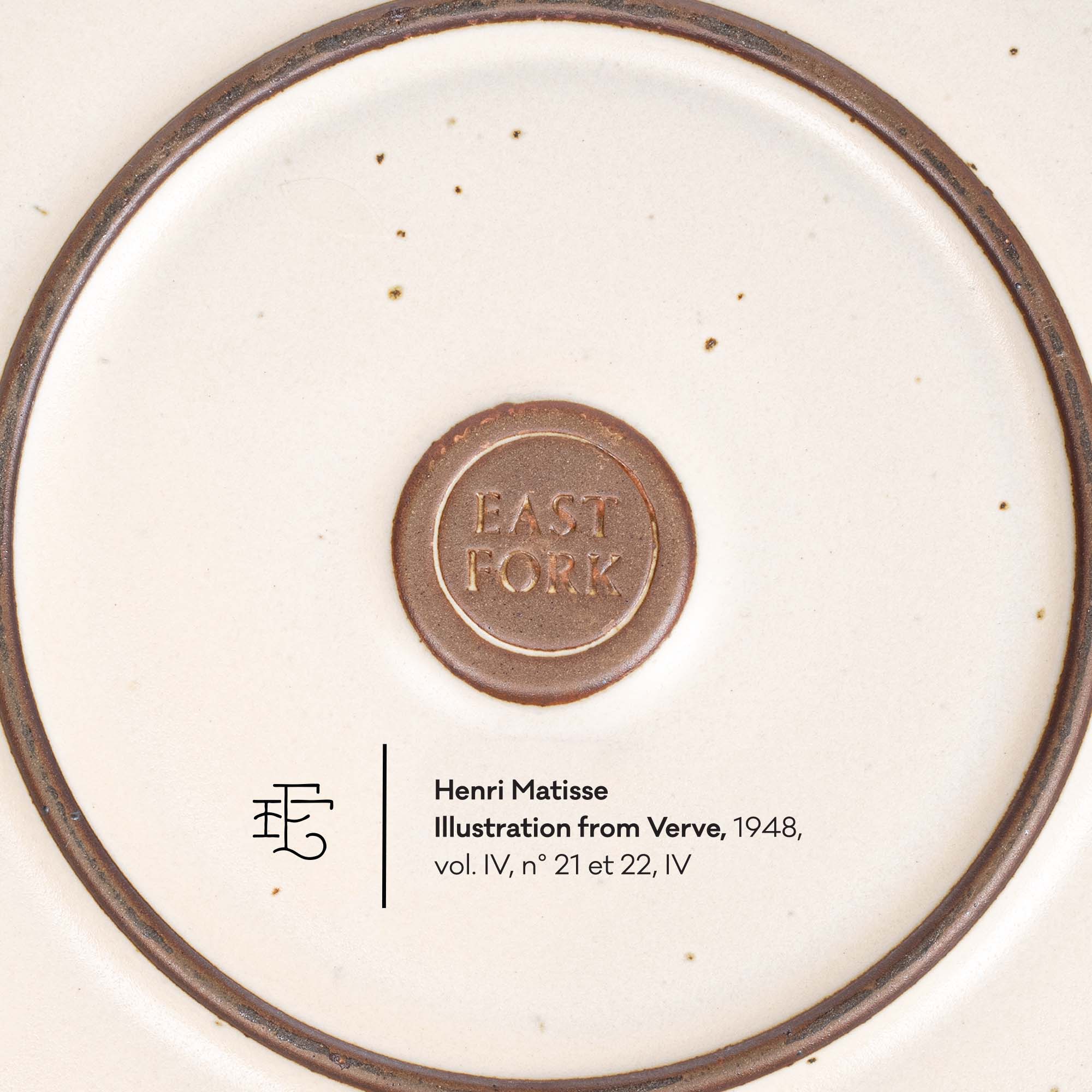 The underside of a ceramic plate or dish showing a circular brown mark that reads 'EAST FORK' with a spoon icon, plus printed copyright text below.