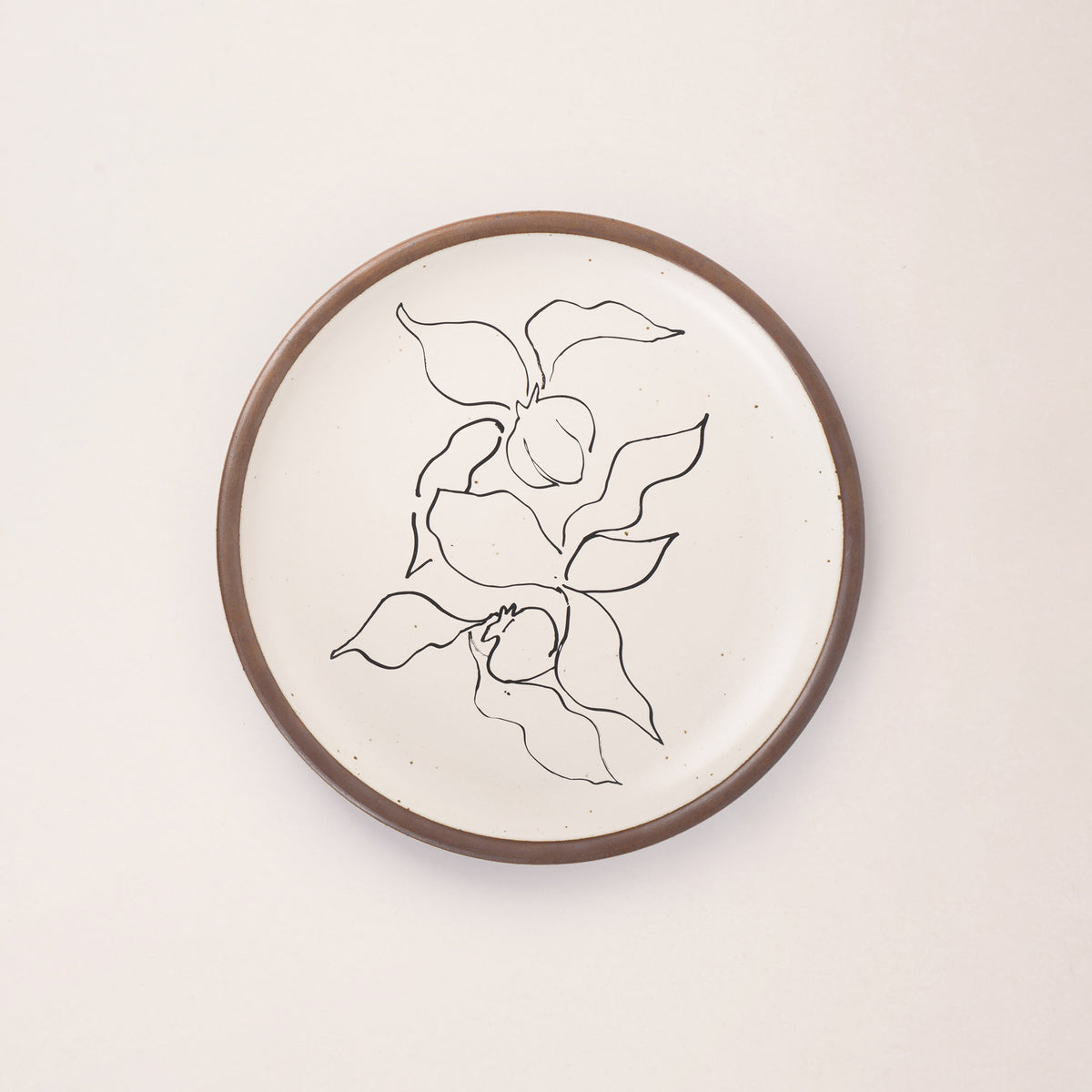 A warm off-white ceramic dinner plate featuring a black Verve illustration by Henri Matisse.