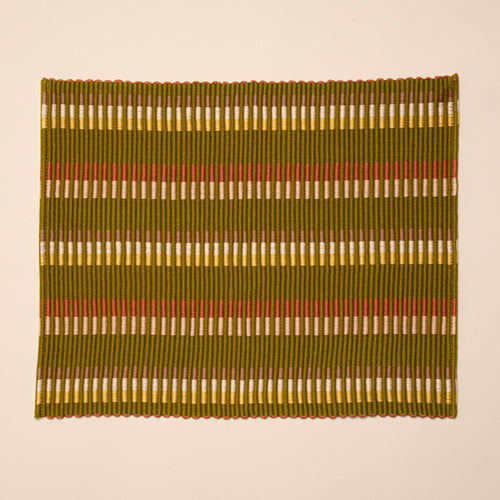 Rectangle placemat with offset stripe design that is hand woven in olive, tan, orange, and yellow colors