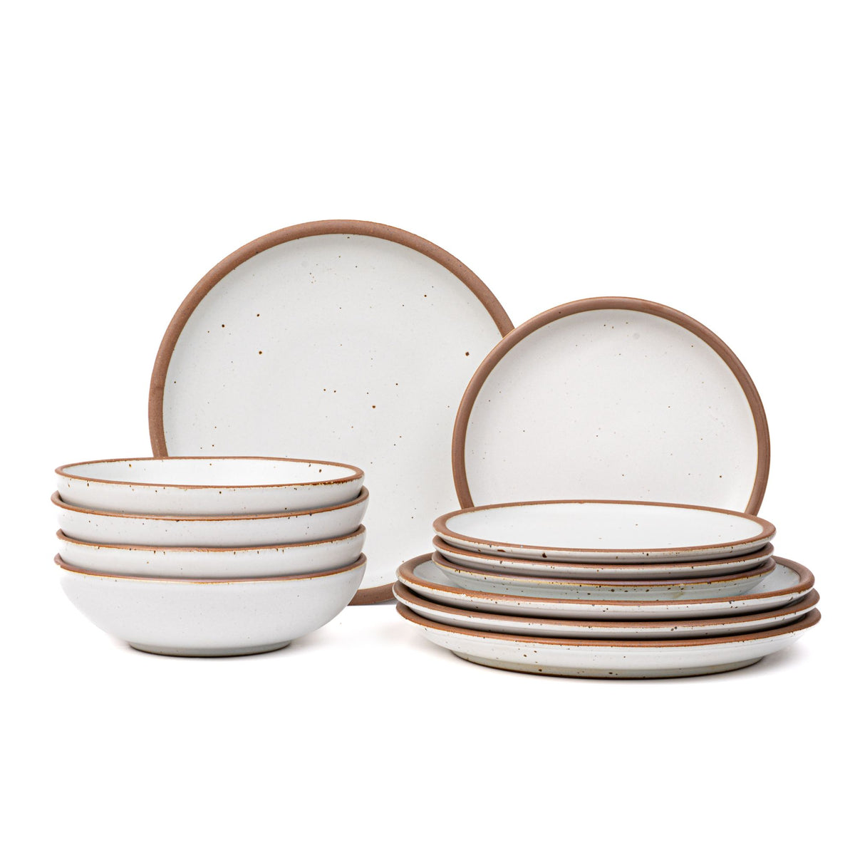 4 ceramic dinner plates, 4 side plates, and 4 shallow dinner bowls in a cool white color with iron speckles and unglazed rims.