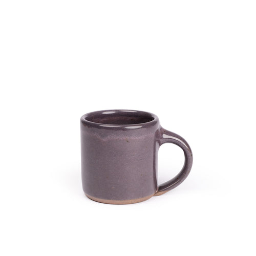 A medium sized ceramic mug with handle in a purple color with a soft glowing sheen.