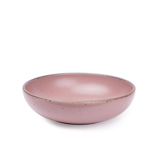 A large shallow serving ceramic bowl in a dusty mauve pink color featuring iron speckles and an unglazed rim.