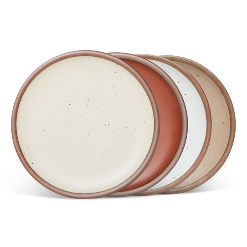 4 dinner sized ceramic plates in a cool terracotta, warm off-white, cool white, and warm pale brown colors featuring iron speckles and an unglazed rim