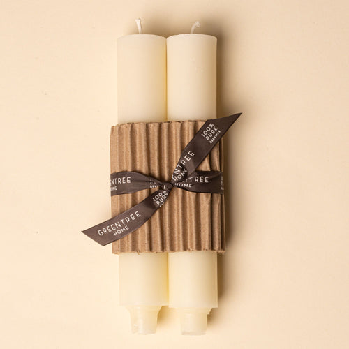 Pair of ivory pillar candles wrapped in corrugated cardboard with a brown ribbon