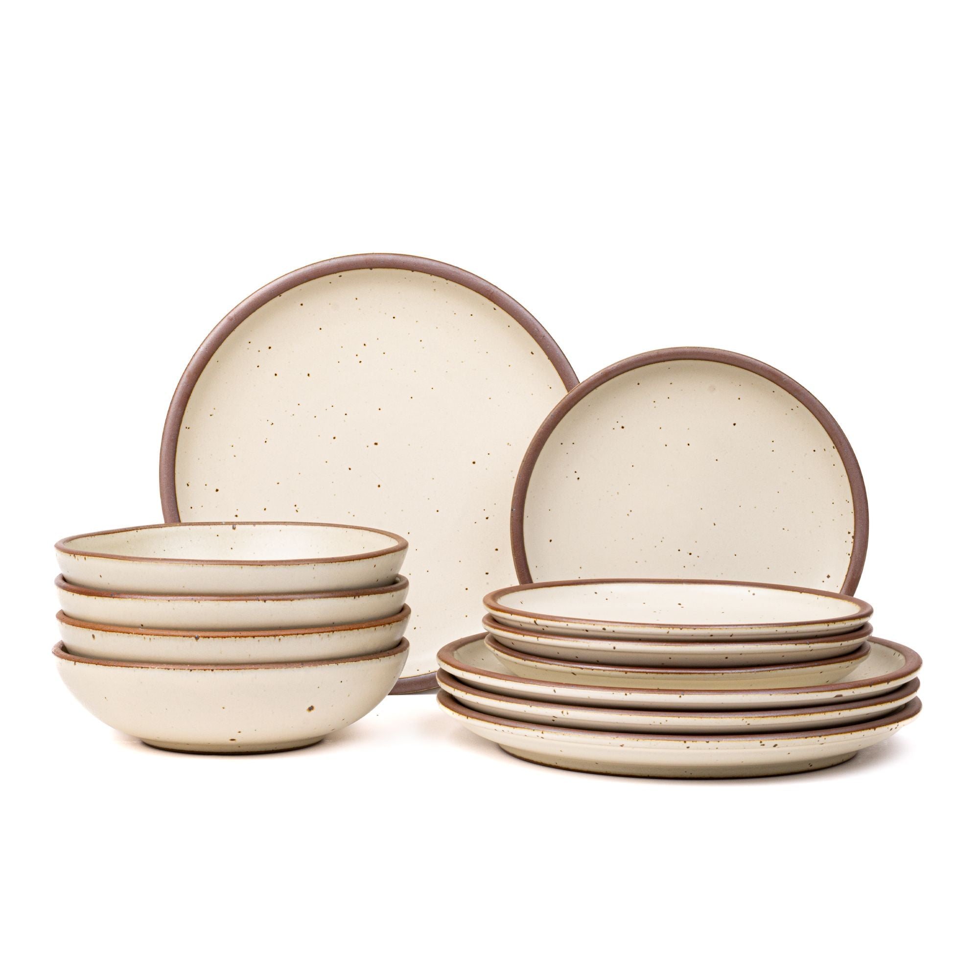 4 ceramic dinner plates, 4 side plates, and 4 shallow dinner bowls in a warm off-white color with iron speckles and unglazed rims.