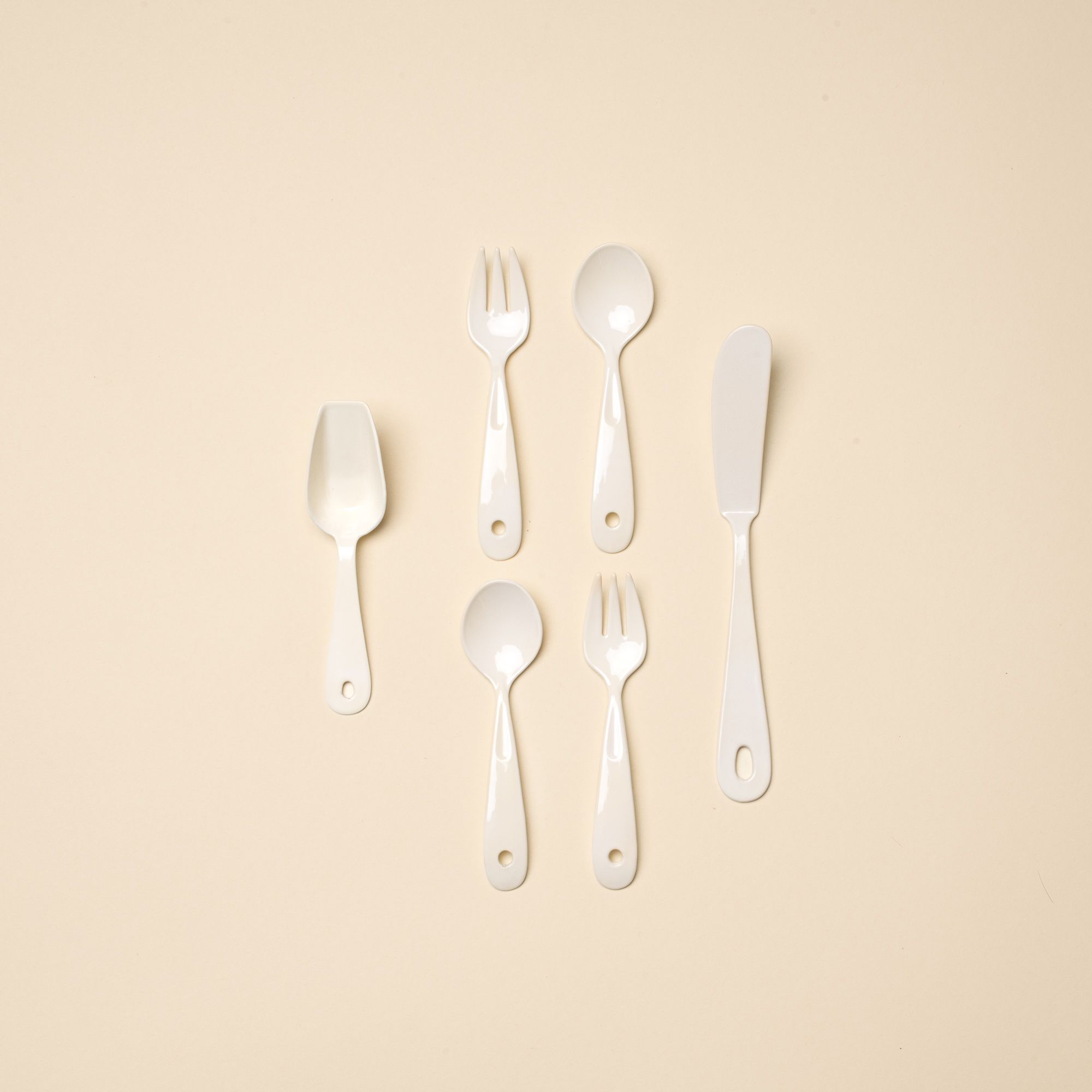 Tiny Scoop, Mini Spoon and Fork Set, and Butter Knife all lined up laying flat.