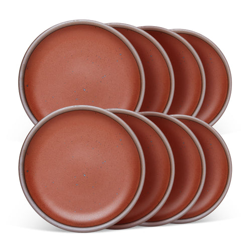 8 medium sized ceramic plates in a cool burnt terracotta color featuring iron speckles and an unglazed rim.