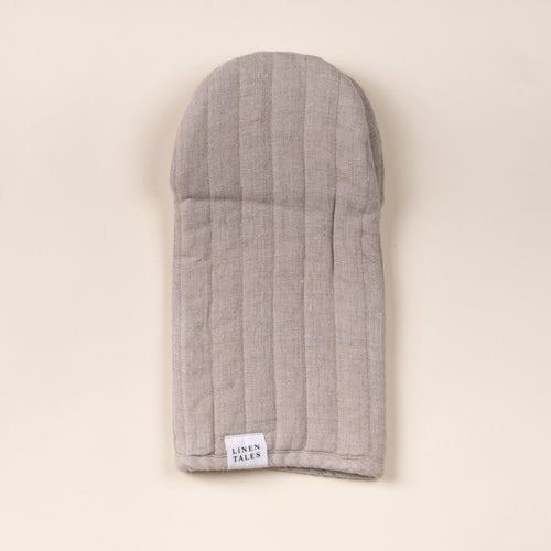 Natural color linen oven mitt with stitched channels and a small ‘Linen Tales’ label, laid flat on a light background.