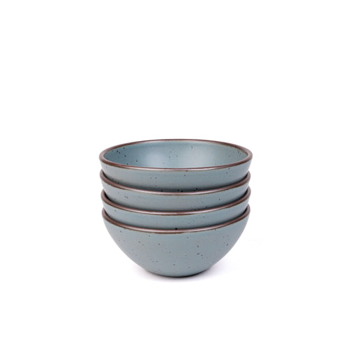 A stack of 4 medium sized rounded ceramic bowls in a blue-grey color featuring iron speckles and an unglazed rim