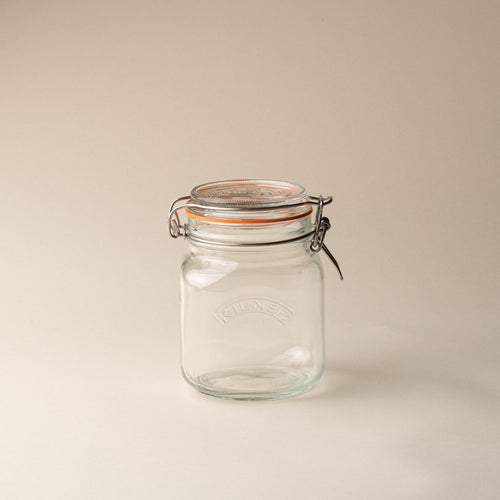 A short storage glass square jar, topped with a lid with a rubber seal and steel clip closure.