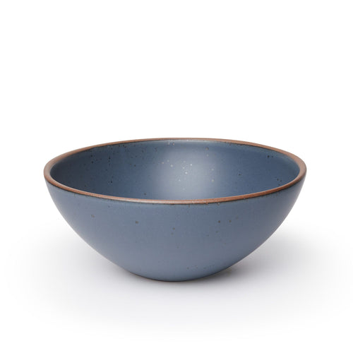 A large ceramic mixing bowl in a toned-down navy color featuring iron speckles and an unglazed rim