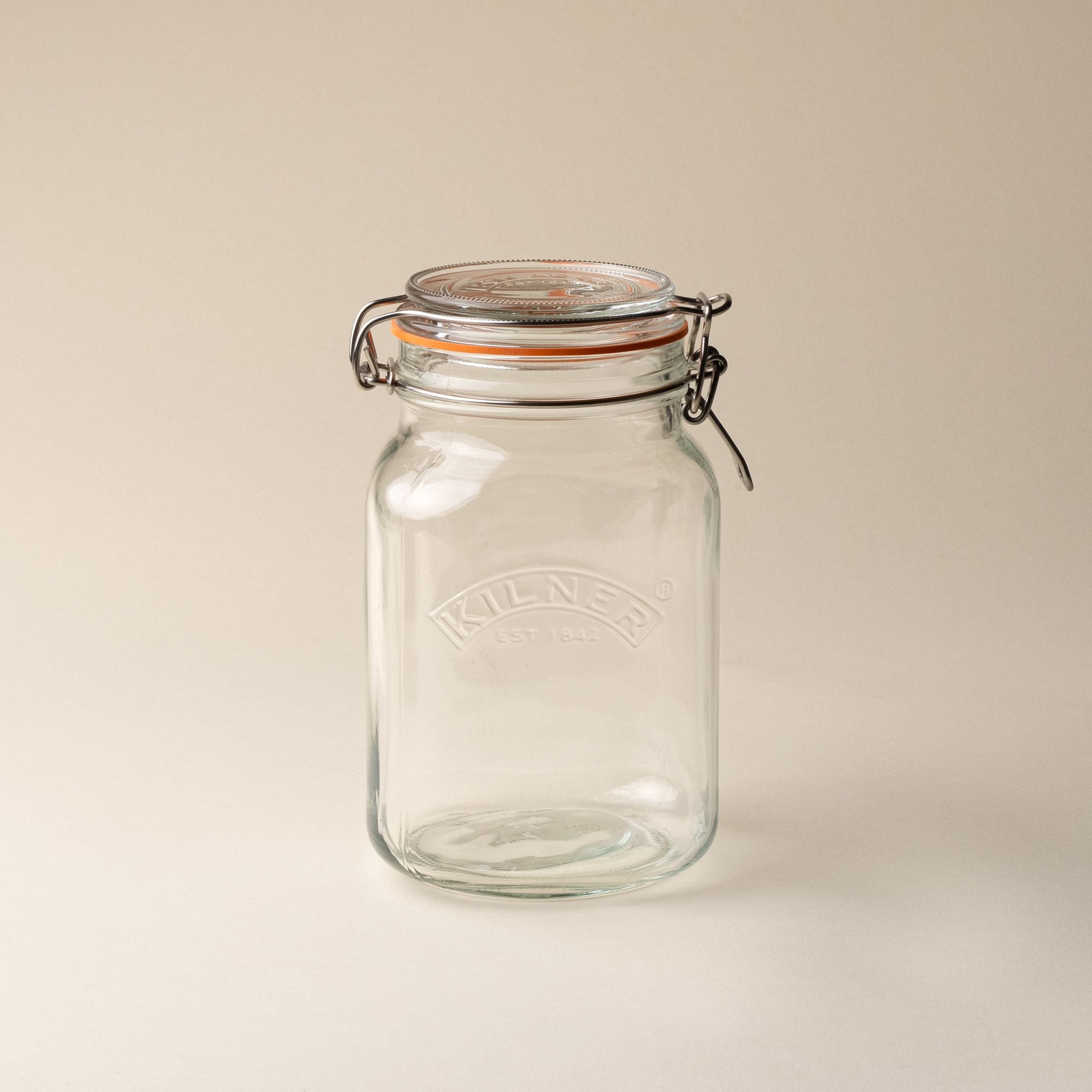A medium storage glass square jar, topped with a lid with a rubber seal and steel clip closure.