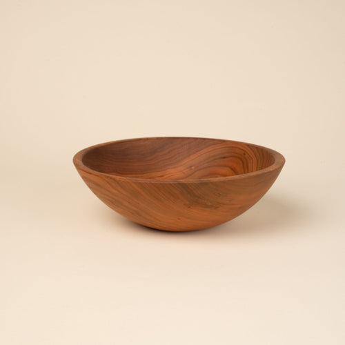 A medium sized round cherry wood bowl