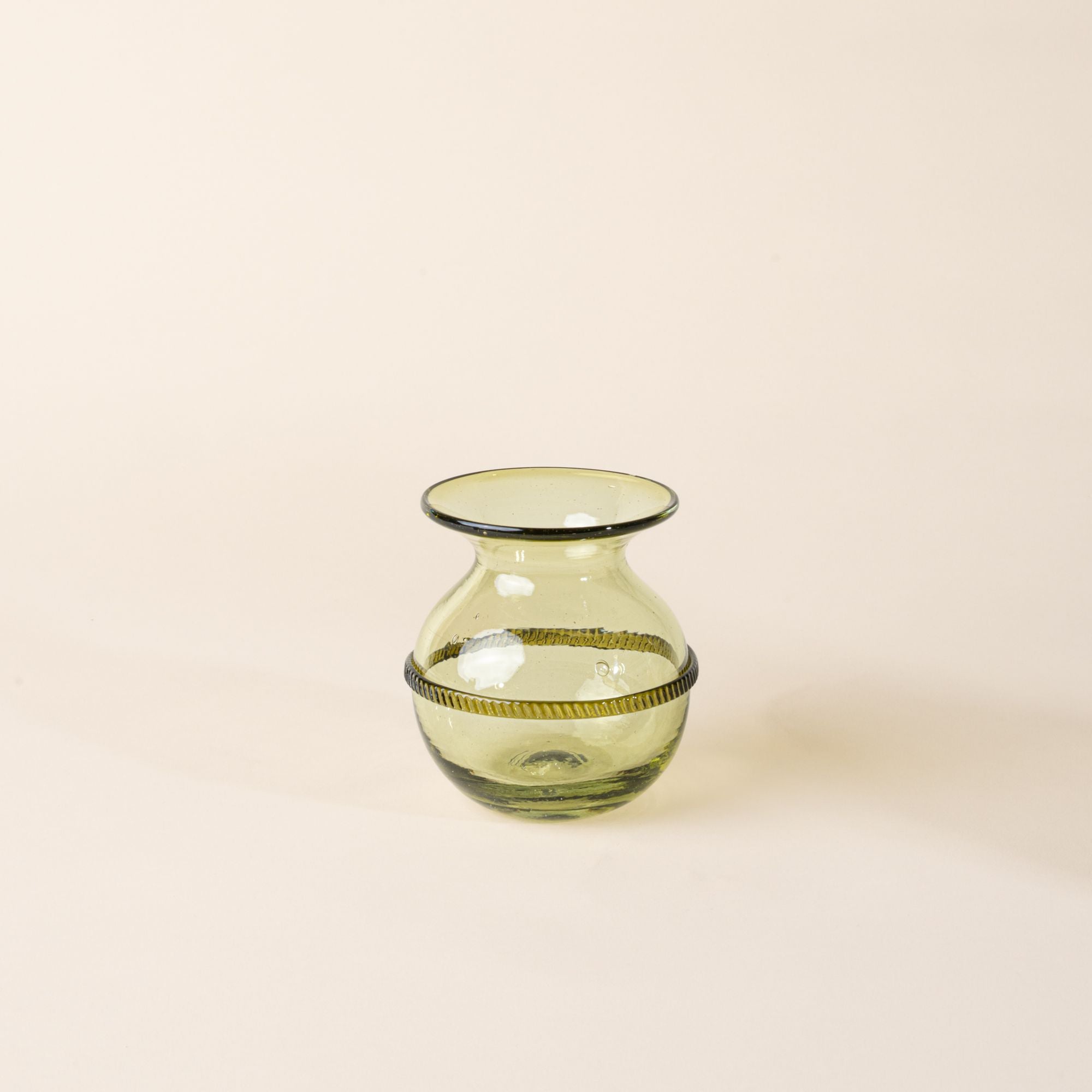 Small light green glass vase with a rounded body, flared rim, and decorative band around the center, displayed on a neutral background.