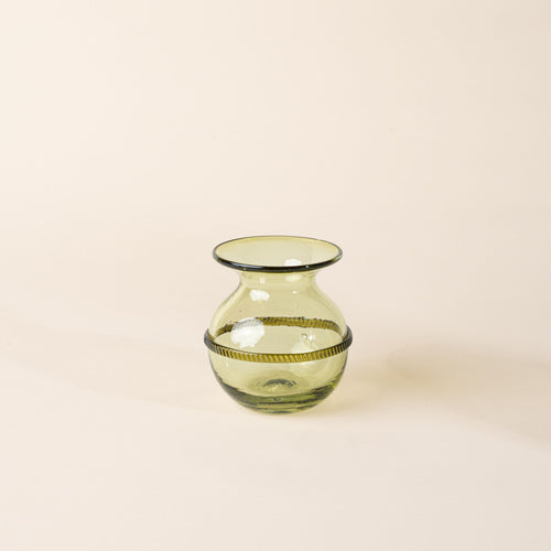 Small light green glass vase with a rounded body, flared rim, and decorative band around the center, displayed on a neutral background.