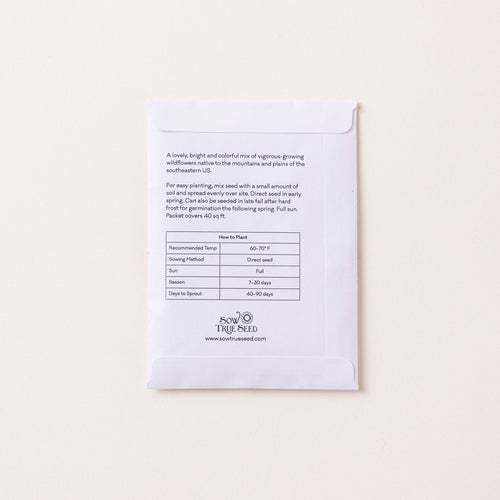 The back of a flat white seed pack filled with text instructions and info.