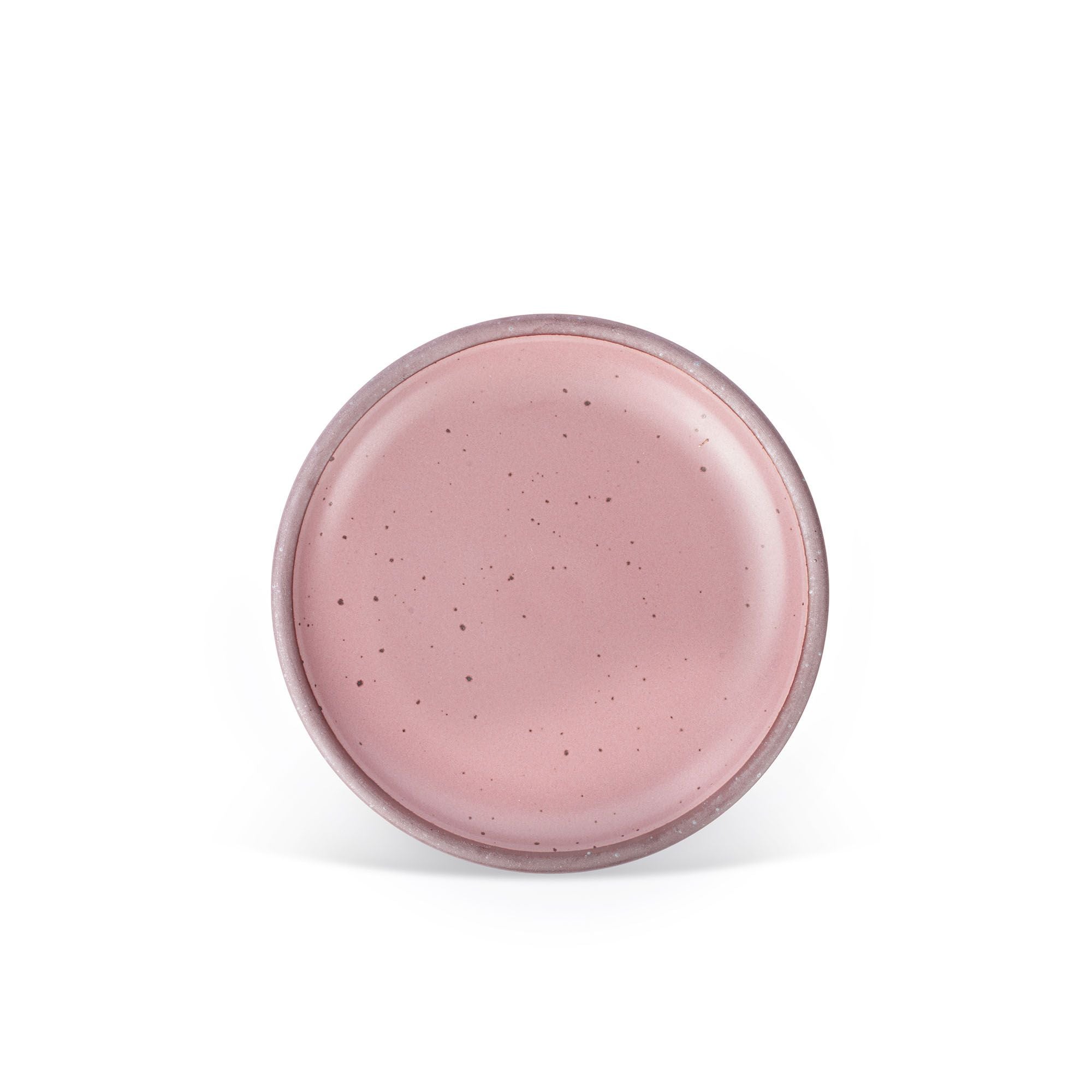 A medium sized ceramic plate in a dusty mauve pink color featuring iron speckles and an unglazed rim.