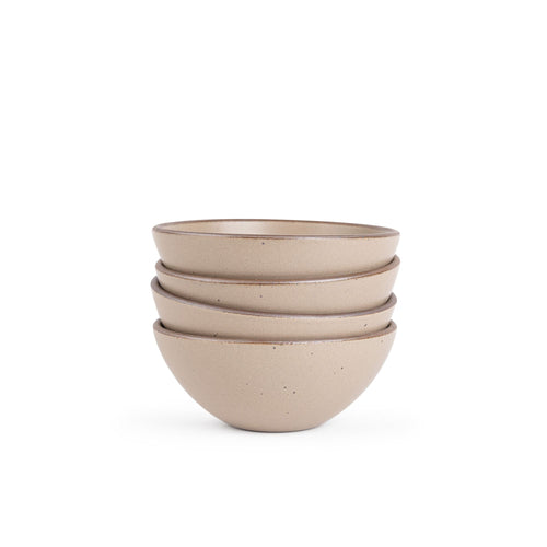 A stack of 4 medium rounded ceramic bowls in a warm pale brown color featuring iron speckles and an unglazed rim